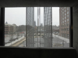 Window of Ponce City Market parking garage, looking through tensile fabric.
